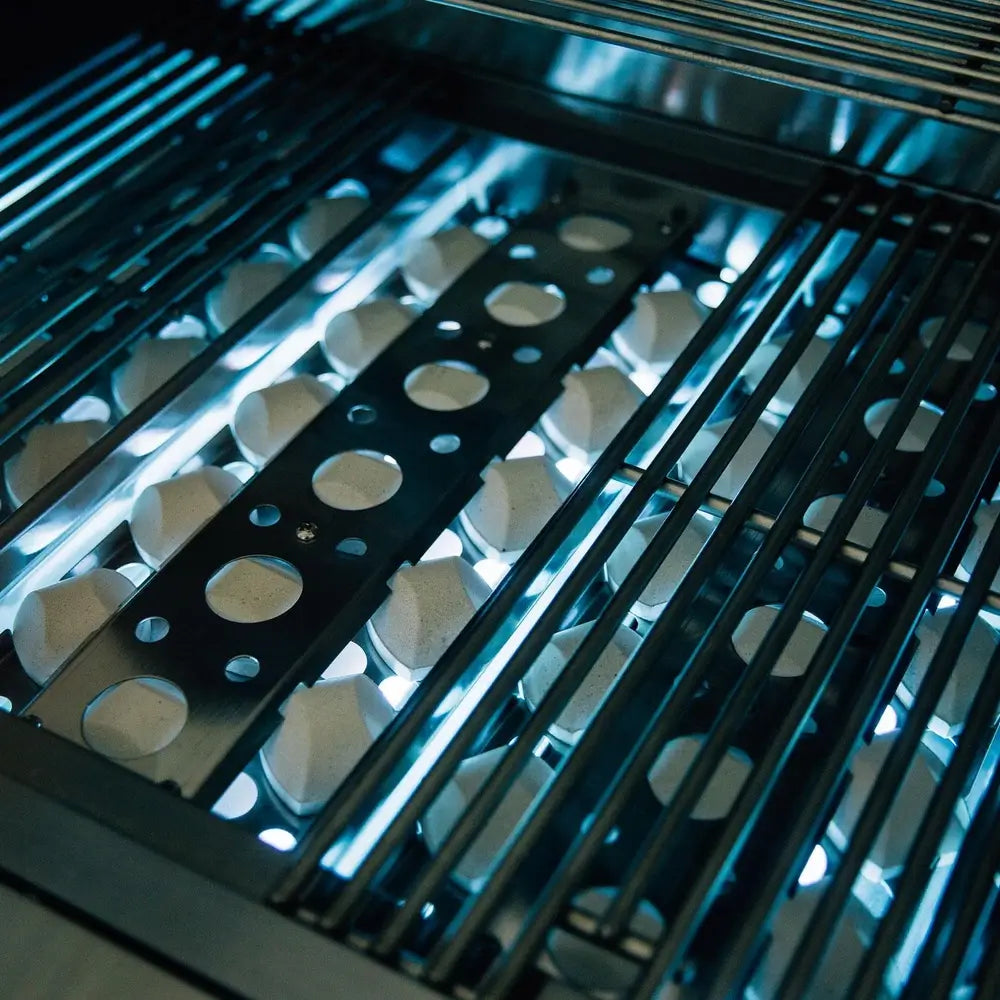 Interior view of Summerset grill with ceramic briquette flame tamers under grates