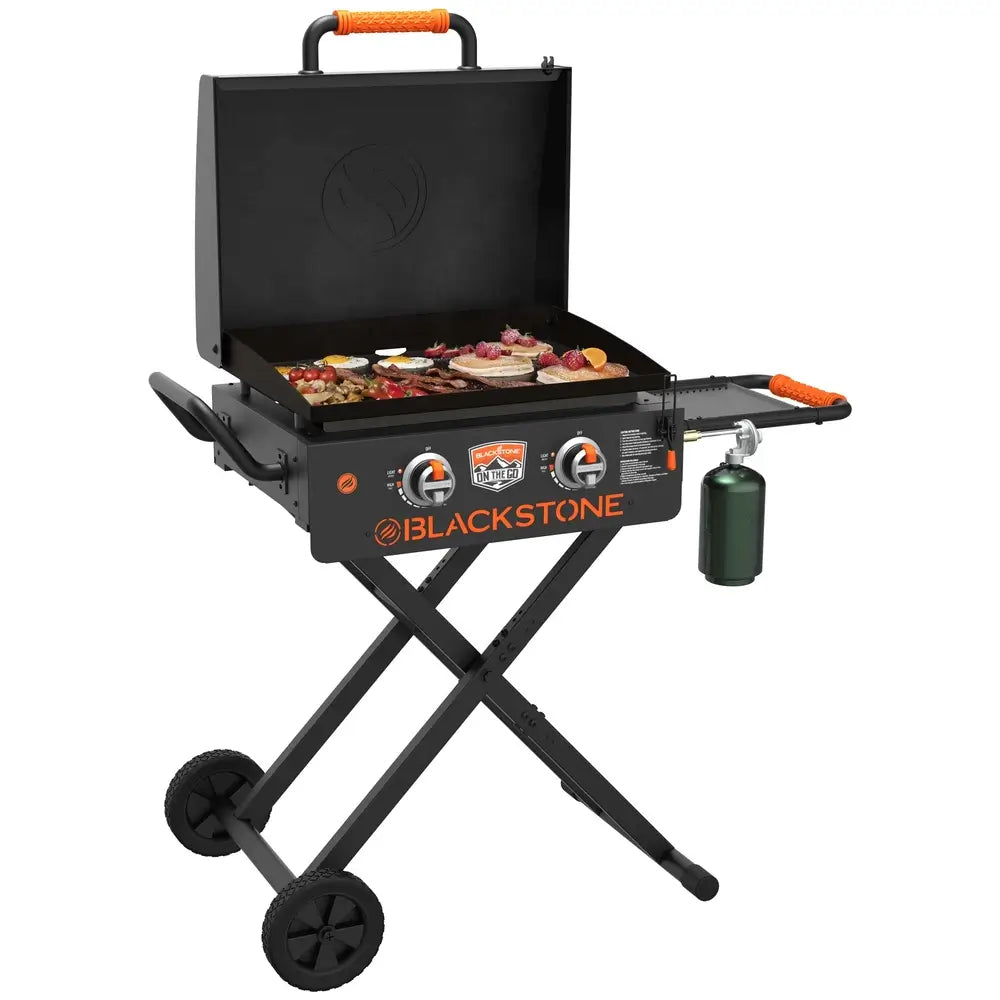 22" Blackstone propane camping griddle cooking pancakes, sausage, and fruit for outdoor breakfast