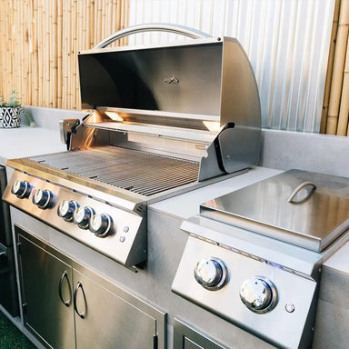 Built-in stainless steel Summerset gas grill with side burner in modern outdoor kitchen