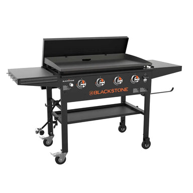 Blackstone 36-inch stainless steel griddle with hood, four burners, side shelves, and storage shelf – ideal for backyard outdoor cooking