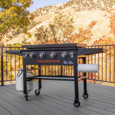 Blackstone 36-inch patio griddle set up on outdoor deck with propane tank and fall mountain backdrop – premium outdoor grilling station