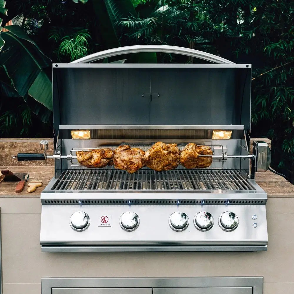 Summerset stainless steel gas grill with rotisserie cooking whole chickens outdoors