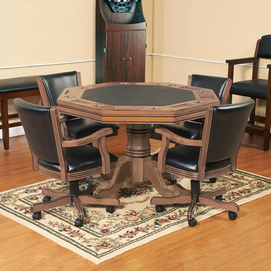 Kingston 3-in-1 poker table set in a home game room with four black faux leather swivel chairs, matching the octagonal poker surface and pedestal base on a decorative rug.