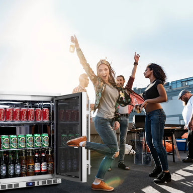 KingsBottle KBU55M beverage fridge in outdoor lifestyle setting with people enjoying a party.