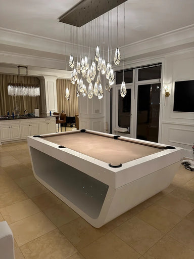 White Billiards Sofia slate pool table with white base and neutral felt under pendant lights