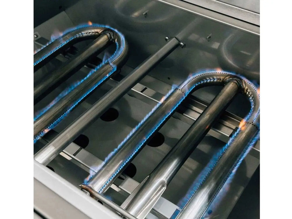 U-shaped stainless steel gas burners with blue flames in outdoor grill.
