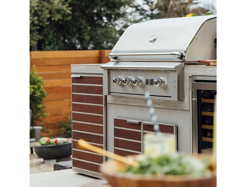Luxury built-in outdoor grill with closed lid in modern backyard kitchen.