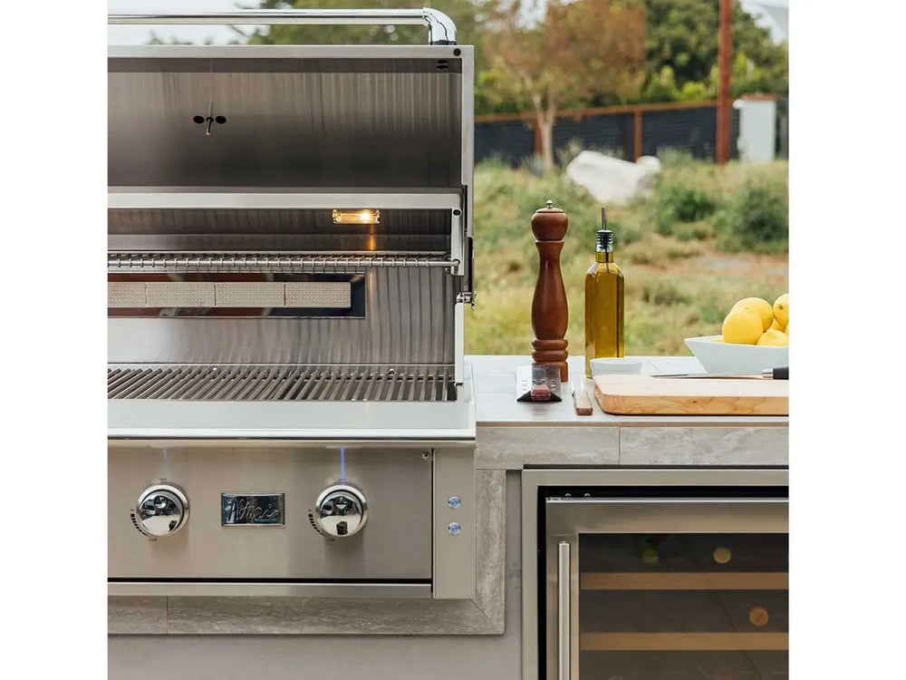 Outdoor gas grill with lid open showing stainless steel grates and infrared rear burner.