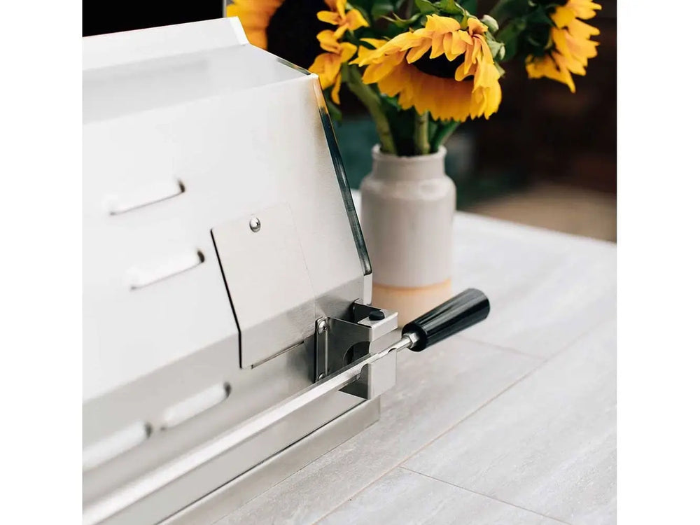 Side view of luxury outdoor grill with lid closed on patio countertop.