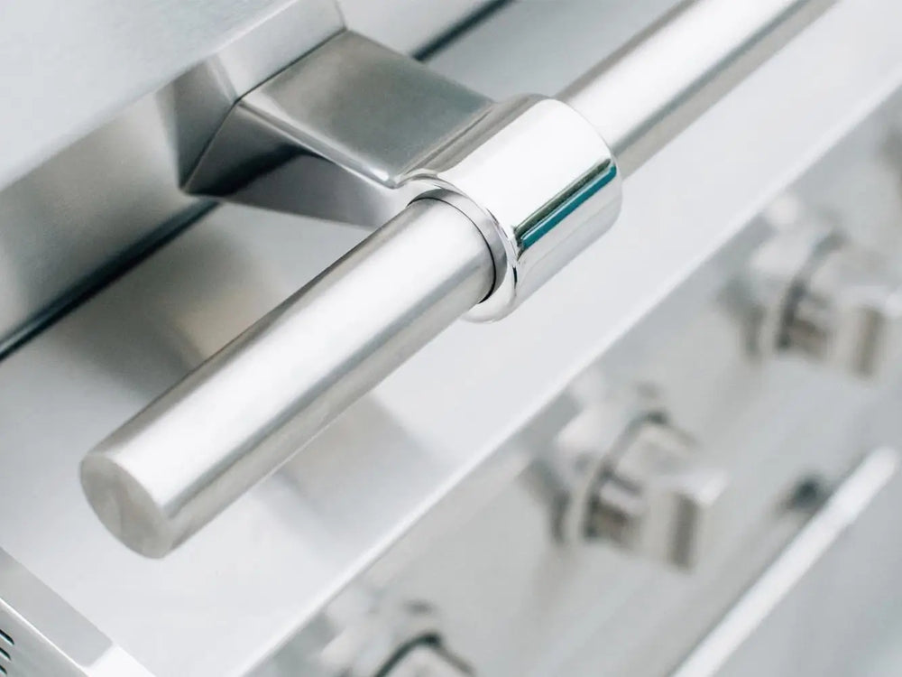 Close-up of stainless steel grill hood handle with polished finish