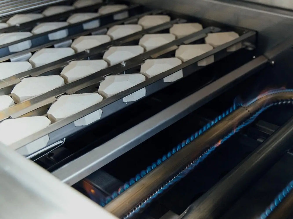 Heavy-duty stainless steel U-burners with ceramic briquettes for even heat distribution on luxury outdoor grill.