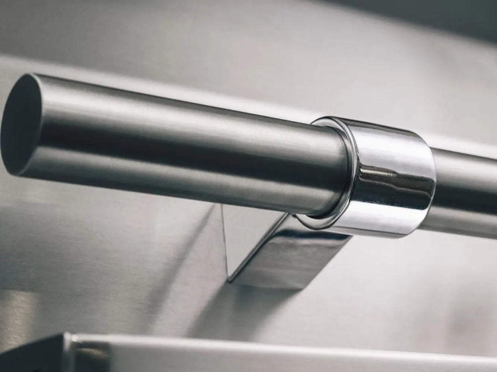 Polished stainless steel grill hood handle for premium American Made Grills outdoor kitchen setup.