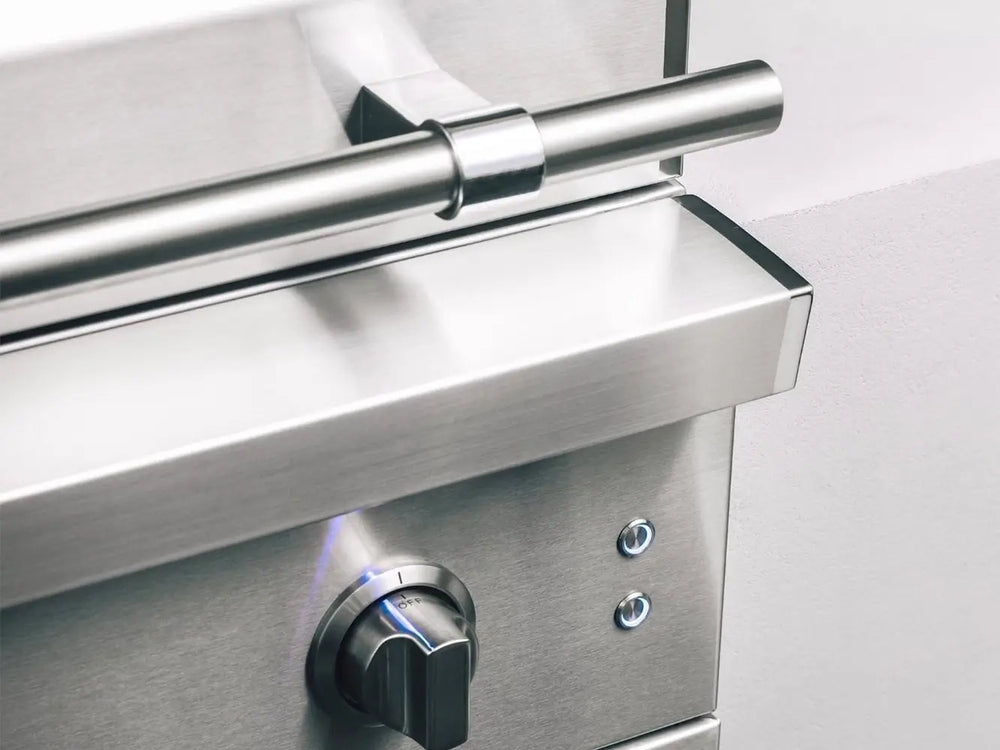 Sleek stainless steel corner detail with control knob and LED-lit ignition buttons on professional gas grill.