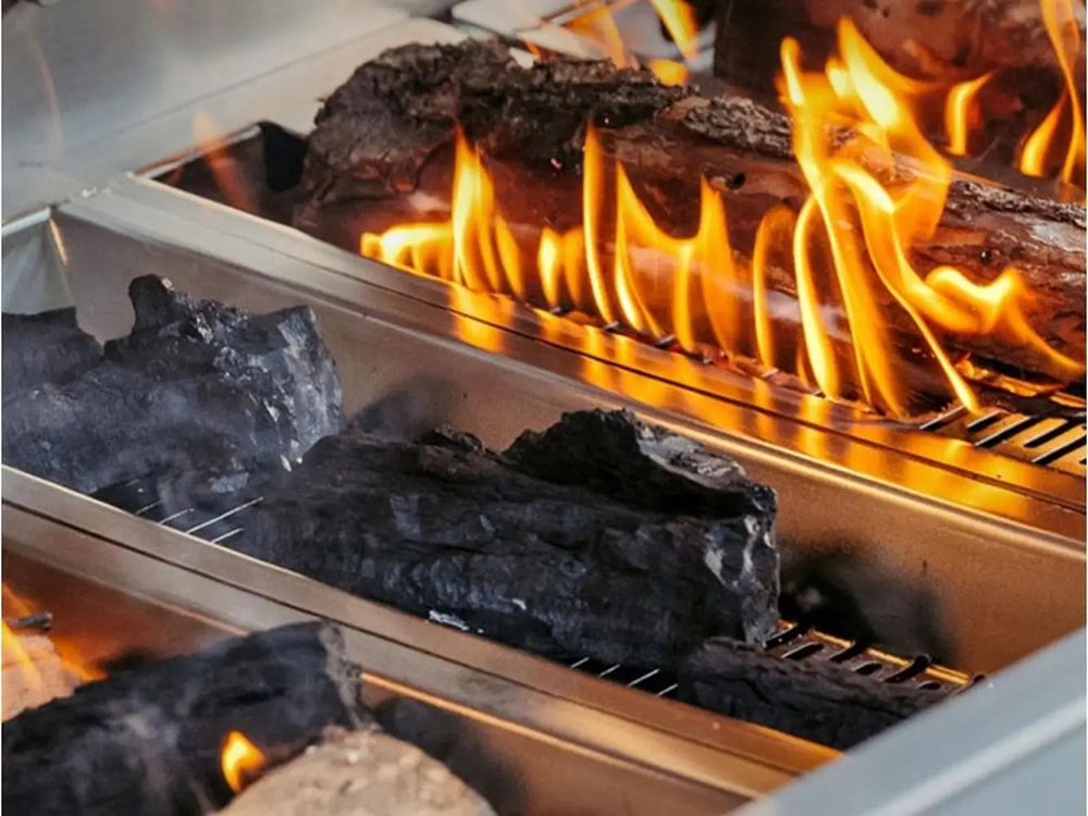 Charcoal and wood logs burning inside luxury outdoor grill