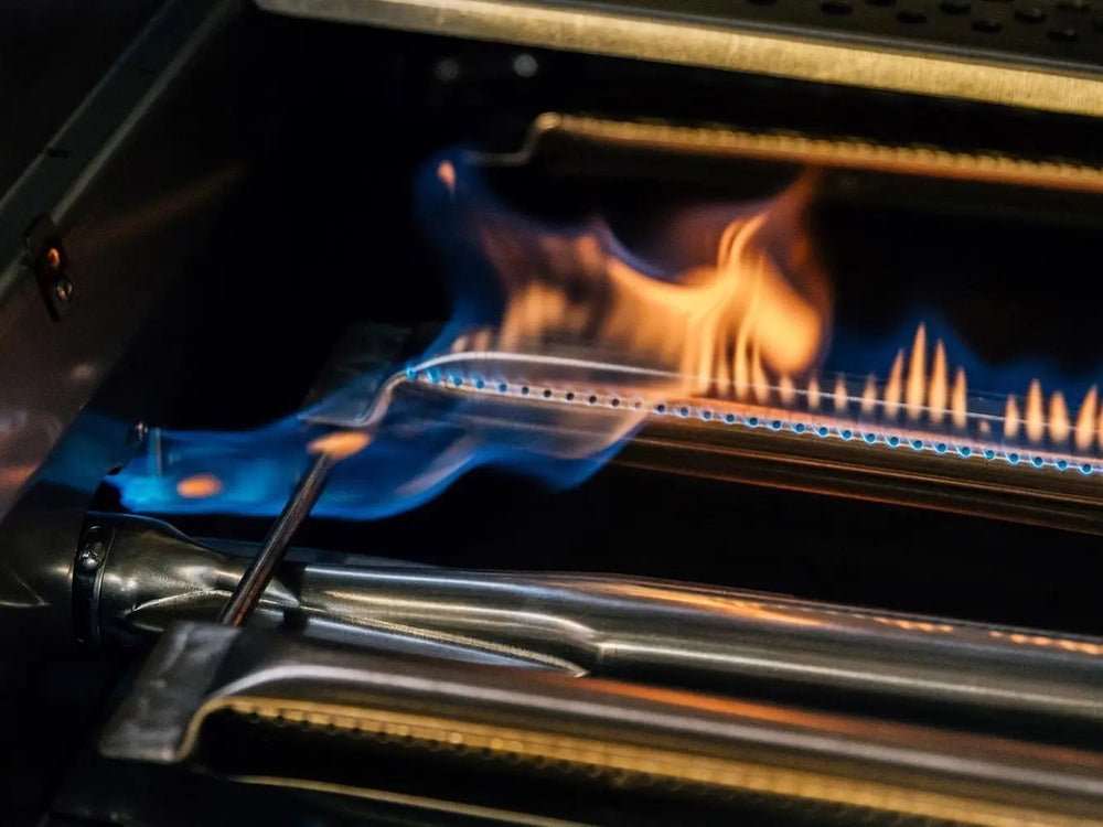 Ignition system igniting powerful U-burners for high-heat searing on premium stainless steel grill.