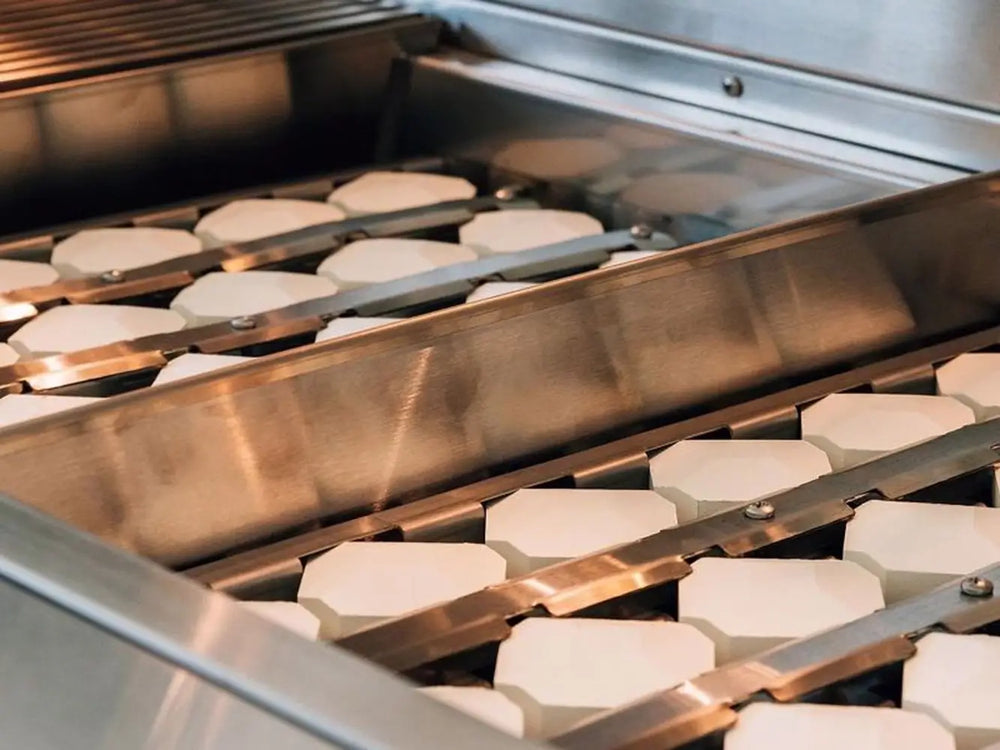 Ceramic briquette flame tamers for even heat distribution