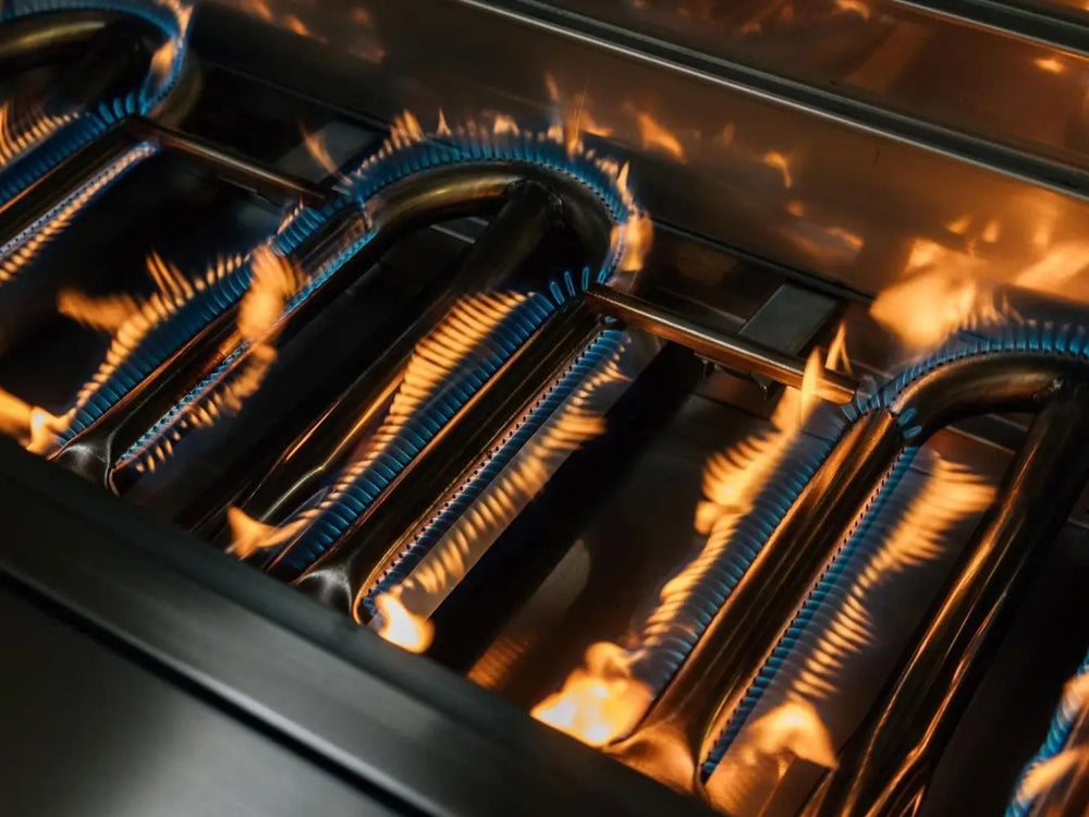 Multiple stainless steel U-burners producing even flames for consistent grilling performance