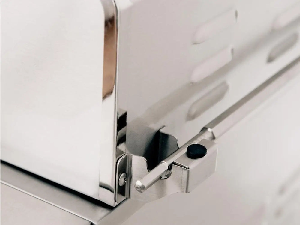 Close-up of stainless steel grill hood latch mechanism for secure closure