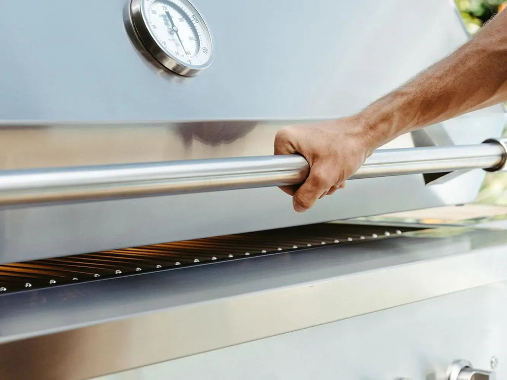 Person lifting premium stainless steel grill hood using sturdy handle