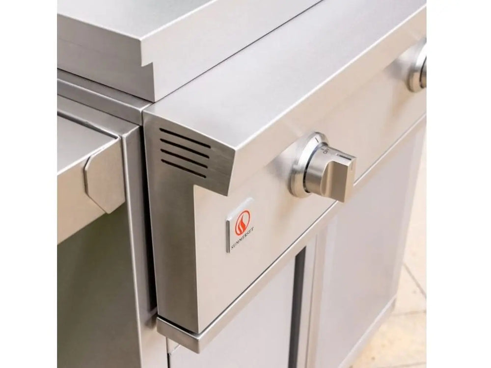 Close-up of stainless steel outdoor griddle control knob and vented side panel