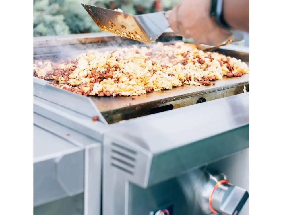 Cooking scrambled eggs and meat on stainless steel flat top outdoor griddle