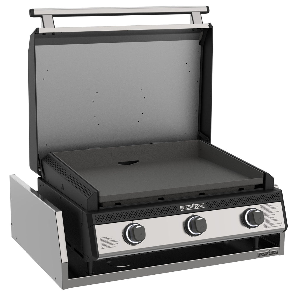 Angled view of Blackstone 28-inch drop-in gas griddle with open stainless steel hood and triple burner layout