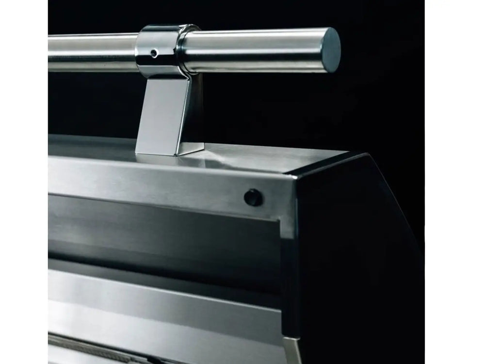 Close-up of polished stainless steel grill hood handle on luxury outdoor grill.