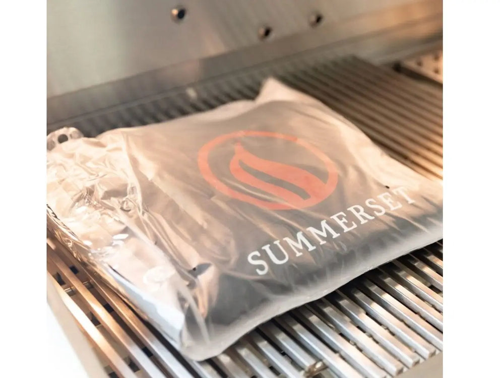 Summerset grill cover packaged on stainless steel cooking grates.
