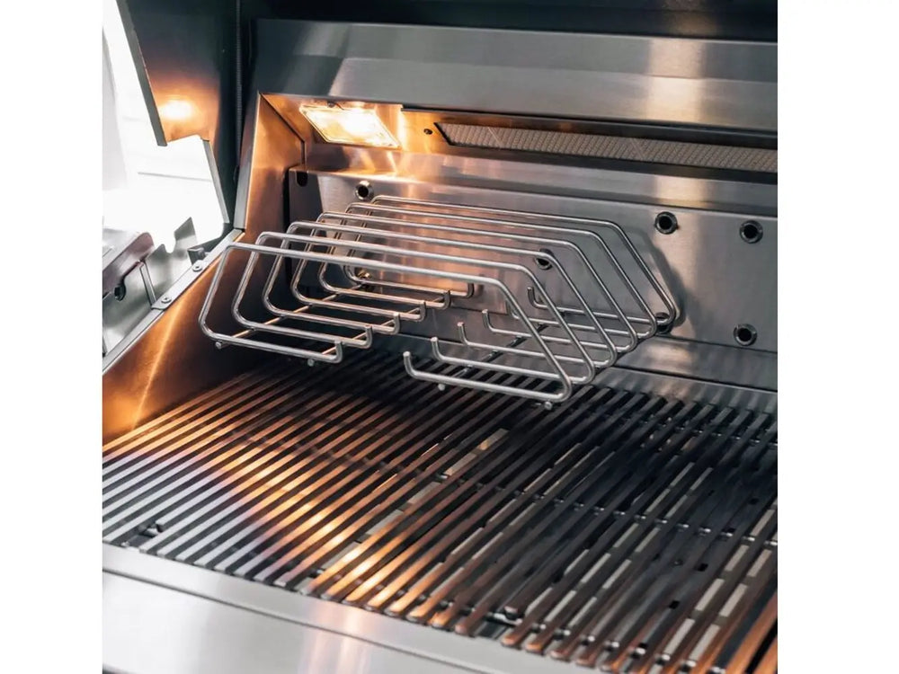 Adjustable warming rack and cooking grates inside stainless steel gas grill with built-in lights.
