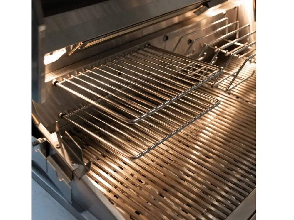 Close-up of stainless steel cooking grates and warming rack inside a premium outdoor gas grill.