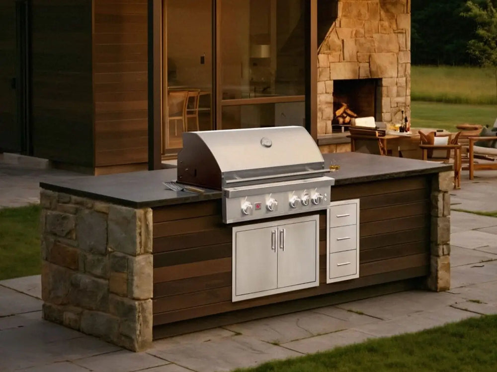 Stone outdoor kitchen island featuring built-in stainless steel gas grill and storage drawers.