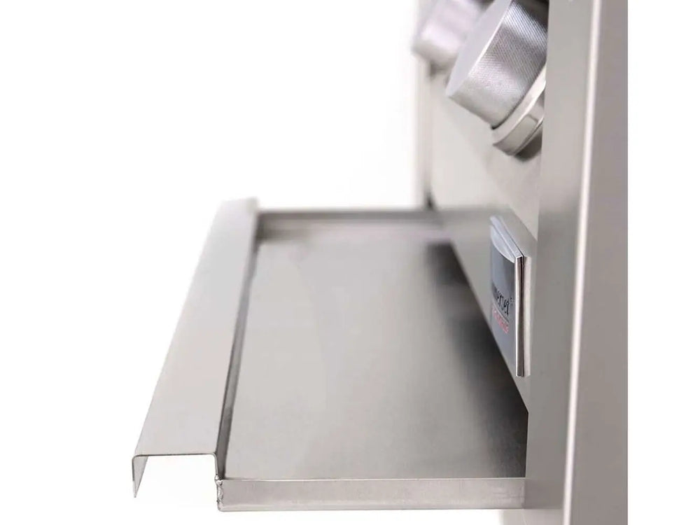 Removable stainless steel drip tray beneath control panel of outdoor gas grill.