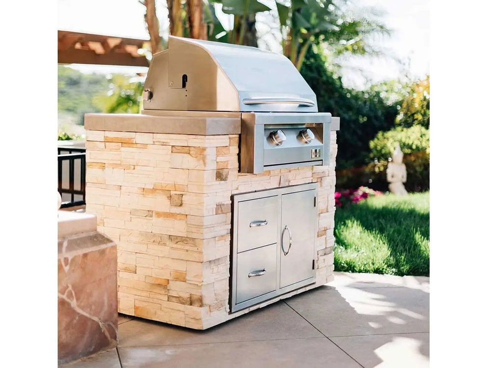 Outdoor stone island featuring stainless steel built-in two-burner gas grill with storage doors.