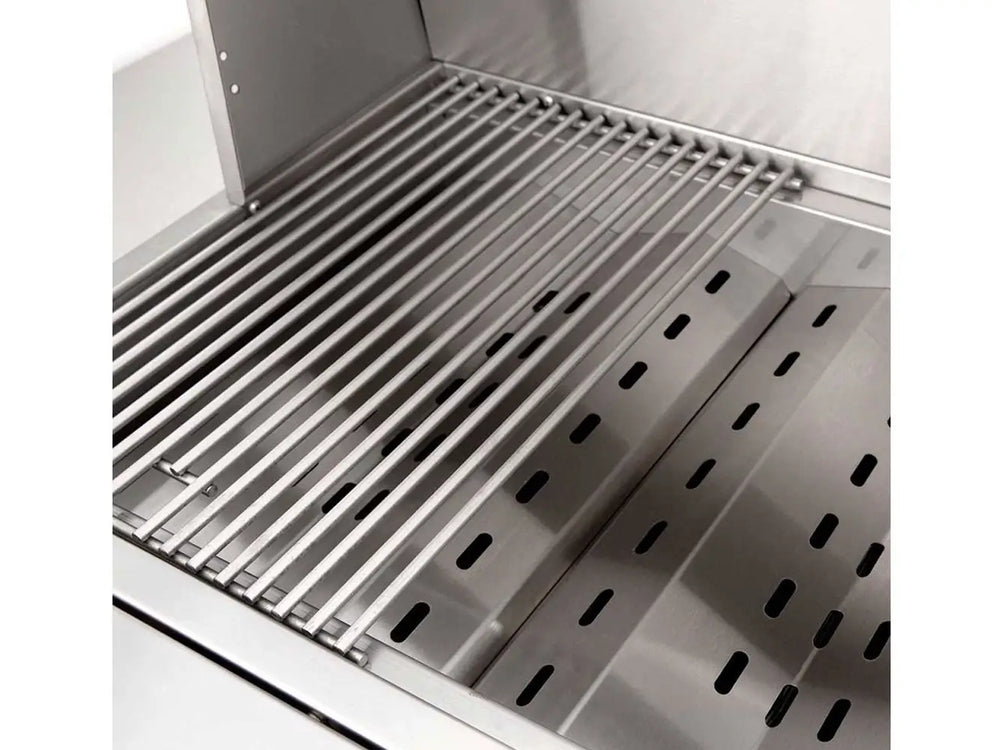 Stainless steel gas grill interior with cooking grate and angled heat plates visible.
