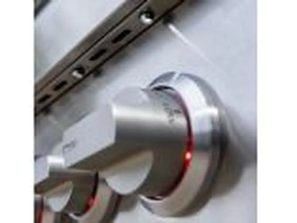 Side view of a stainless steel grill control knob with faint red indicator light.