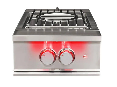Front view of True Flame wok burner with wok ring grate and red backlit dual control knobs.