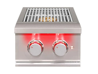 Front view of True Flame power burner with stainless steel grates and dual red LED-lit control knobs.