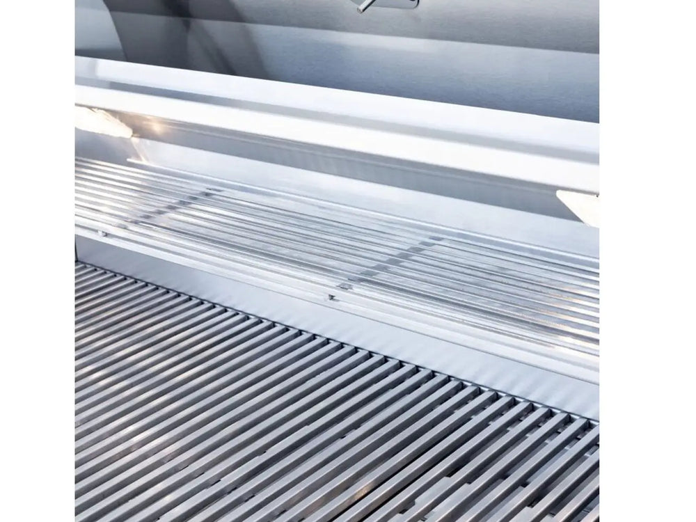 Stainless steel grill interior with warming rack and LED lights above cooking grates.
