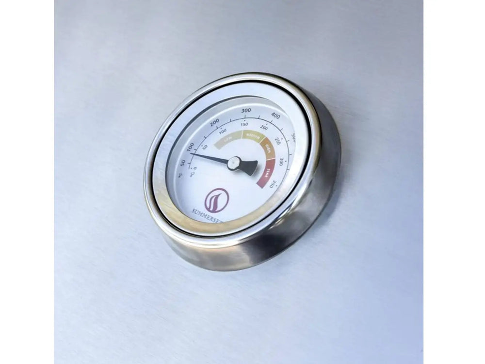 Stainless steel temperature gauge with Summerset logo on outdoor grill hood.