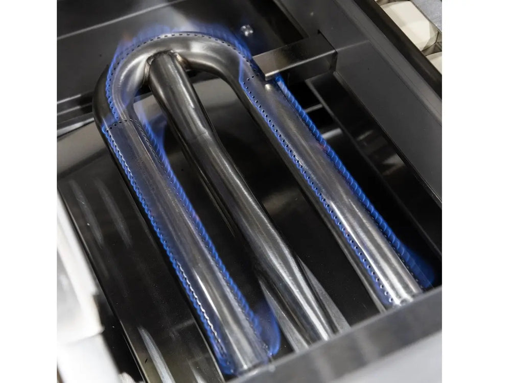 Close-up of stainless steel U-shaped gas burner with blue flames in outdoor grill.