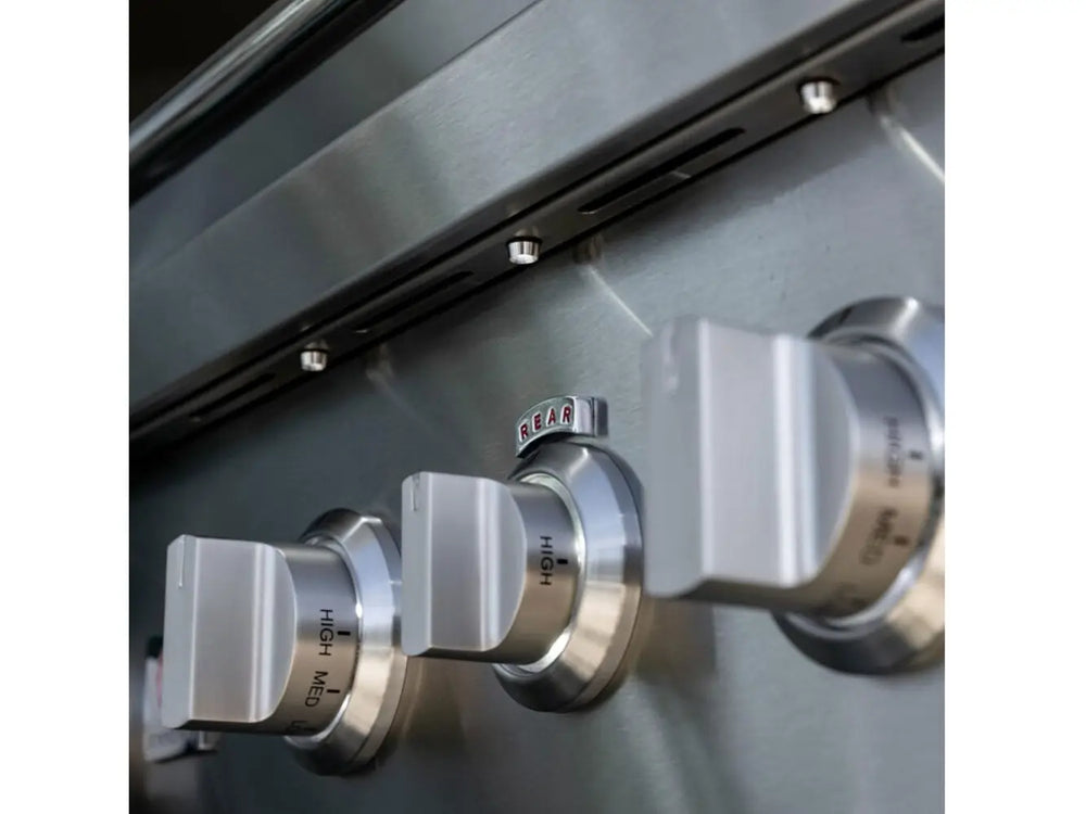 Close-up of stainless steel control knobs labeled high, medium, and rear burner.