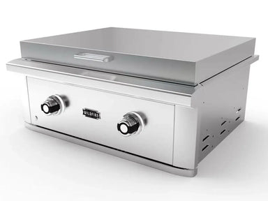 Angled view of Wildfire Ranch Pro 30" 304 SS Built-In Griddle showcasing premium stainless steel construction, rear ventilation cutouts, and a wide flat griddle surface with integrated lid and ergonomic control knobs.