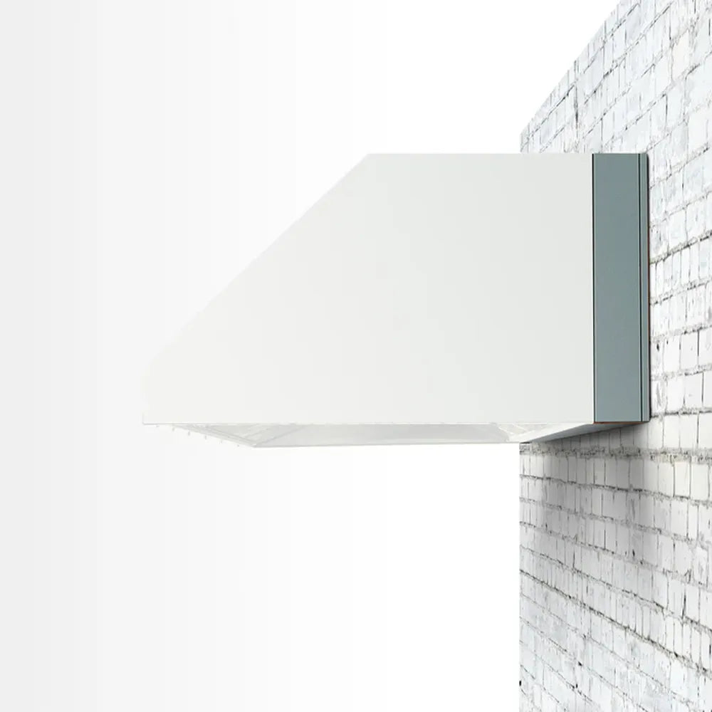 TrueFlame 4" stainless steel spacer bracket on outdoor vent hood, mounted on brick wall.