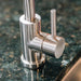 Close-up of Summerset stainless steel modern faucet base and lever handle on outdoor sink.