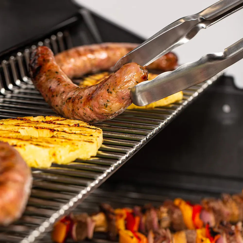 Broil King Imperial S 470 built-in gas grill cooking sausages and pineapple