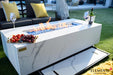 Close-up of the integrated sliding drawer storage located beneath the Carrara Bianco frame, specifically designed to store the matching porcelain burner lid.