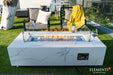 High-end patio setting featuring the Carrara Bianco fire pit table as a centerpiece, paired with designer white lounge chairs and a modern poolside view.