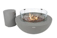 Matching gray concrete gas tank cover placed next to a burning fire bowl on a patio.
