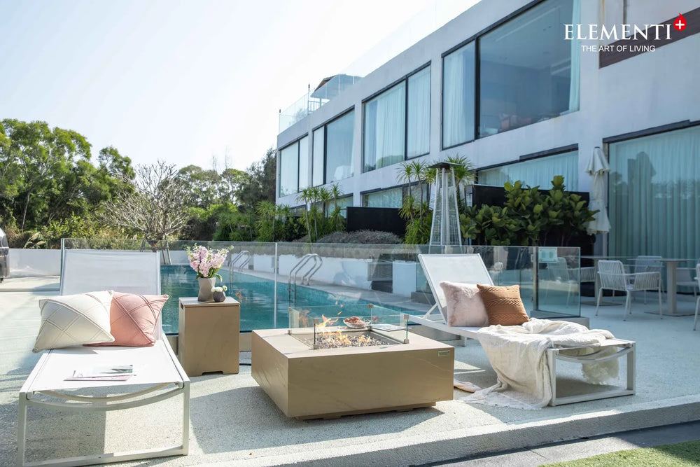 Modern outdoor living space featuring the Uluru rectangular fire pit table and designer seating.