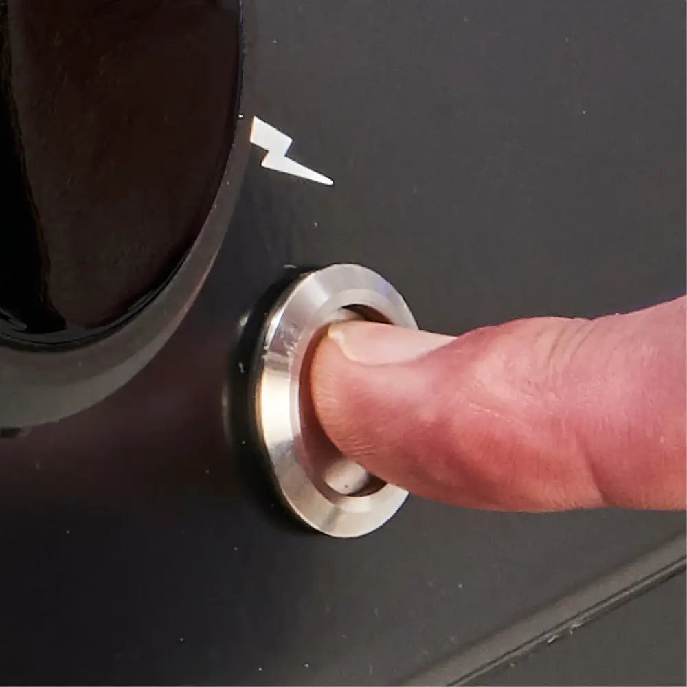Close-up of the Sure-Lite electronic ignition button on a Broil King Baron 420 Shadow Built-In grill.